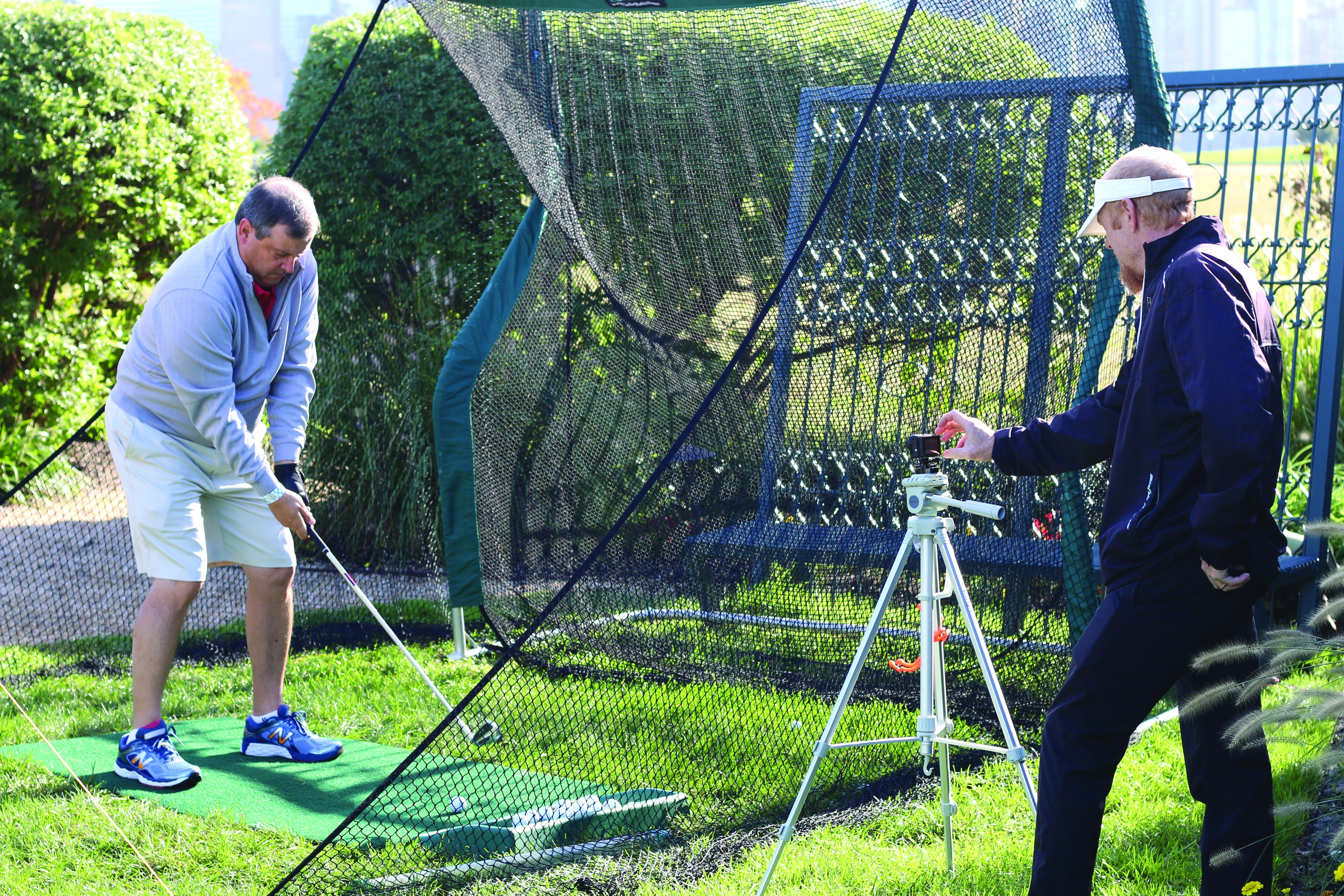 Guest receiving professional golf swing instruction
