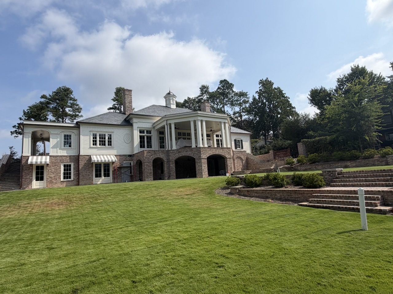 Rear terraces and lawn at ISM’s private Masters hospitality estate