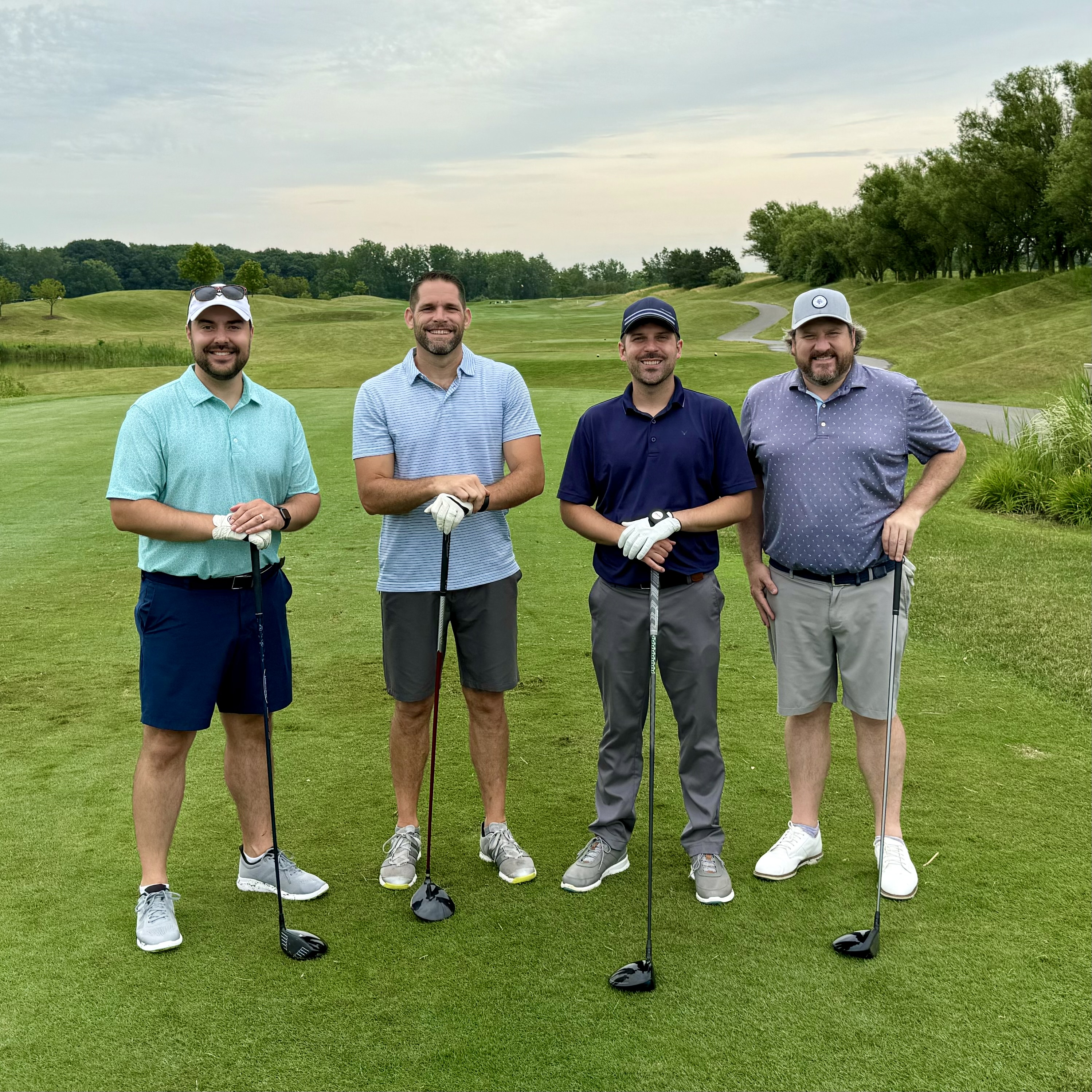 Four golfers together on the course during an ISM golf event