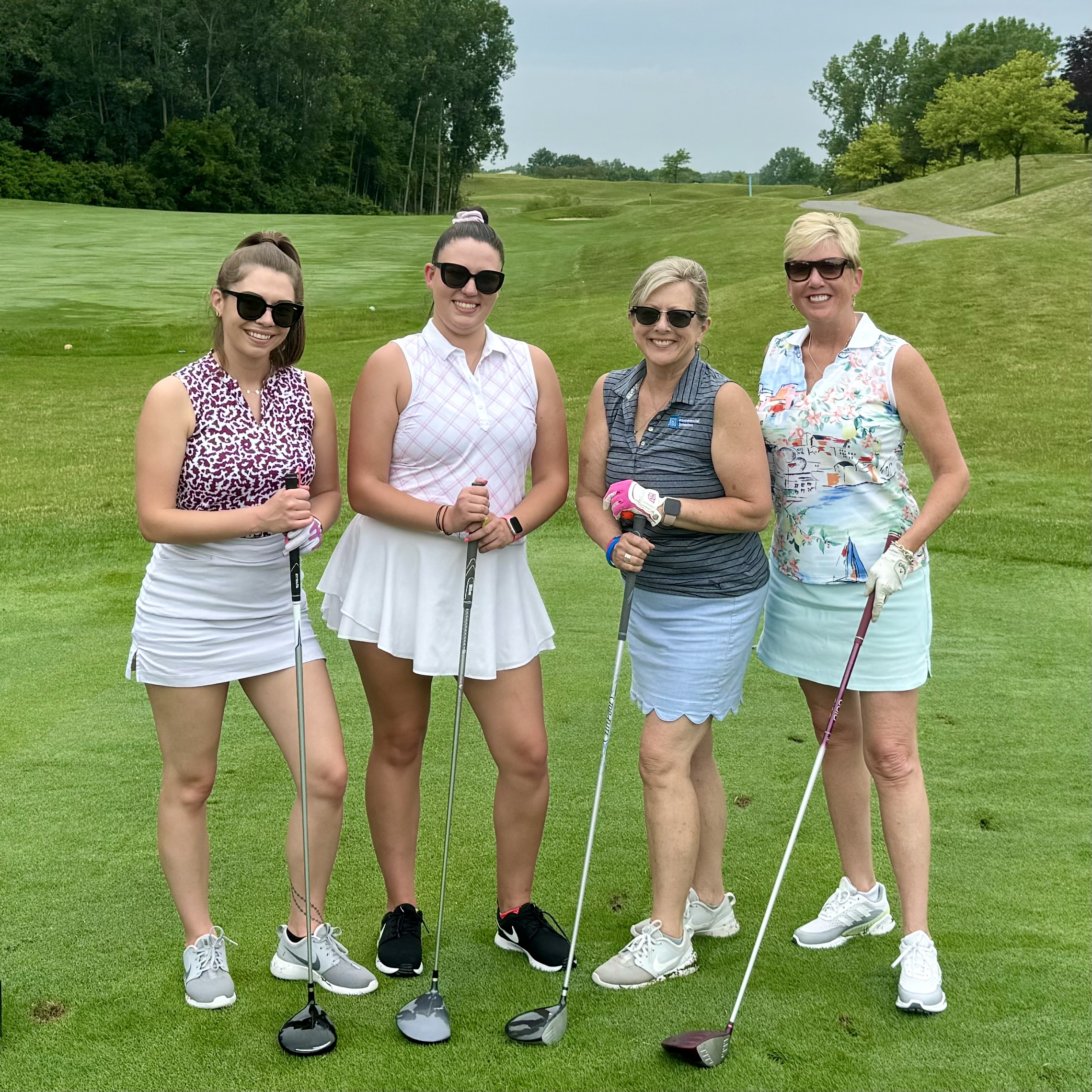 Four golfers together on the course during an ISM golf event