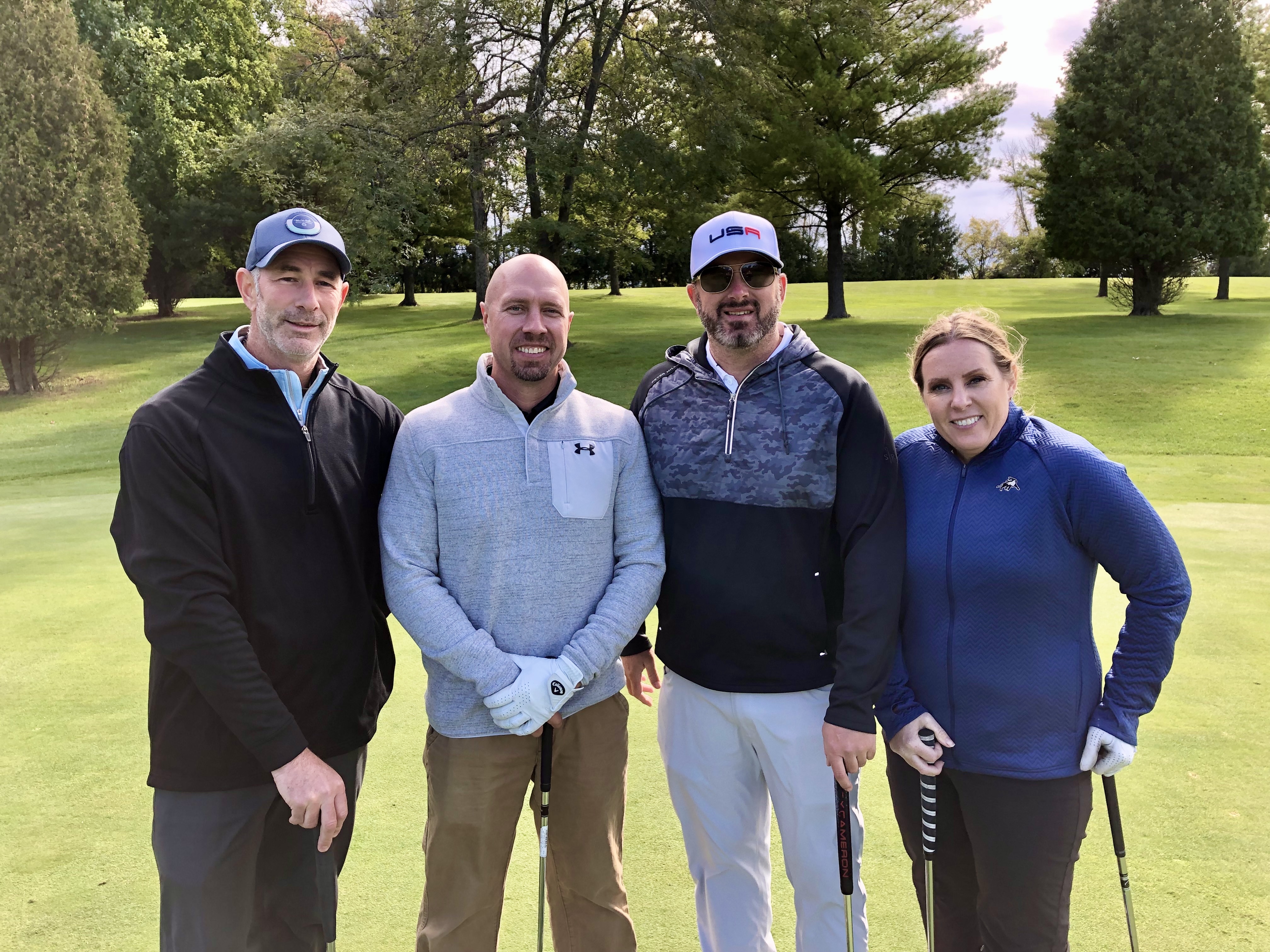 A foursome together on the course during an ISM golf outing