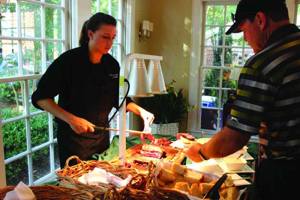 An ISM chef preparing food for guests at a hospitality venue