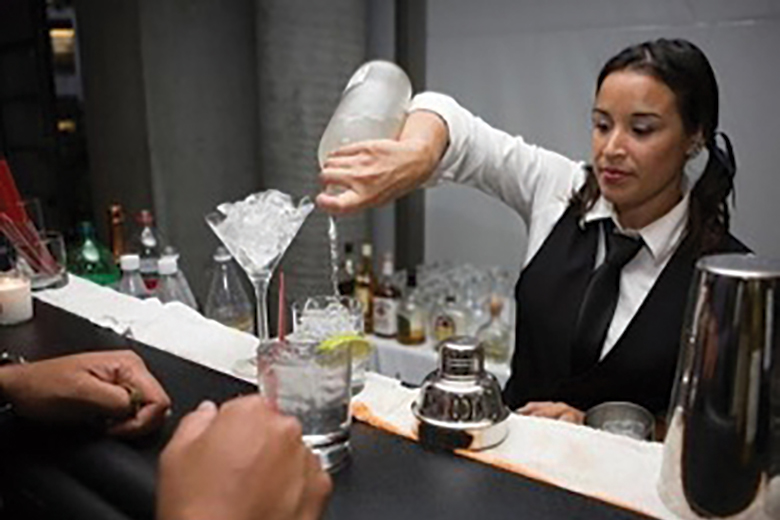 A bartender preparing a drink during an ISM hospitality event