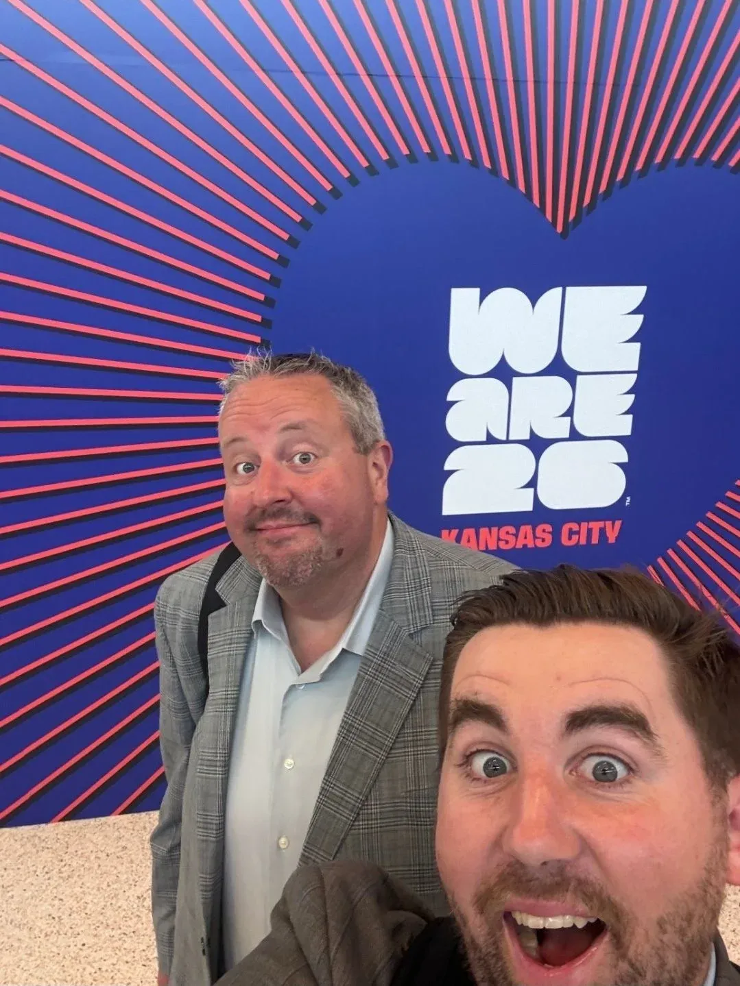 Two guests beside World Cup event signage