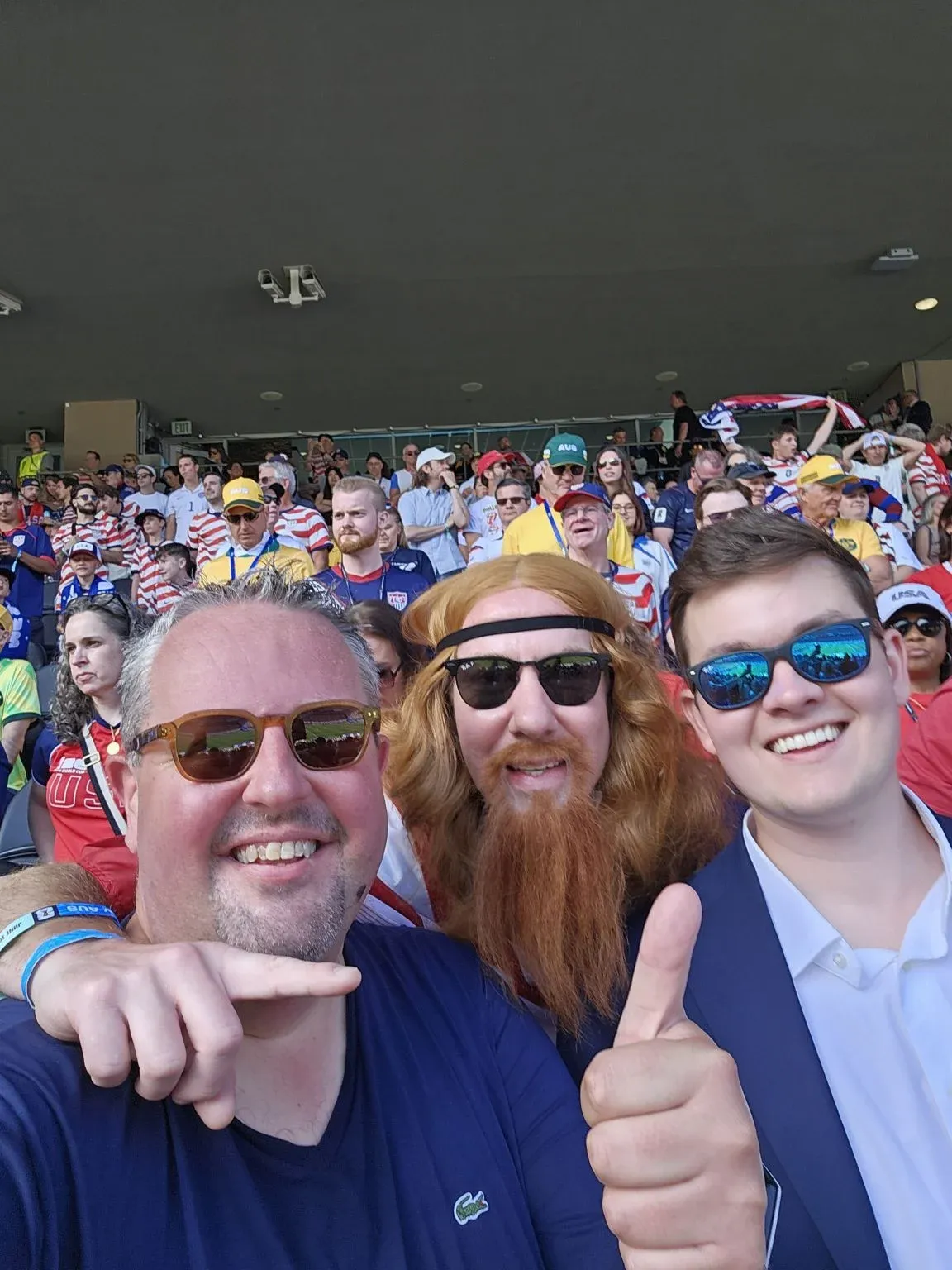 Three guests watching a match from stadium seats