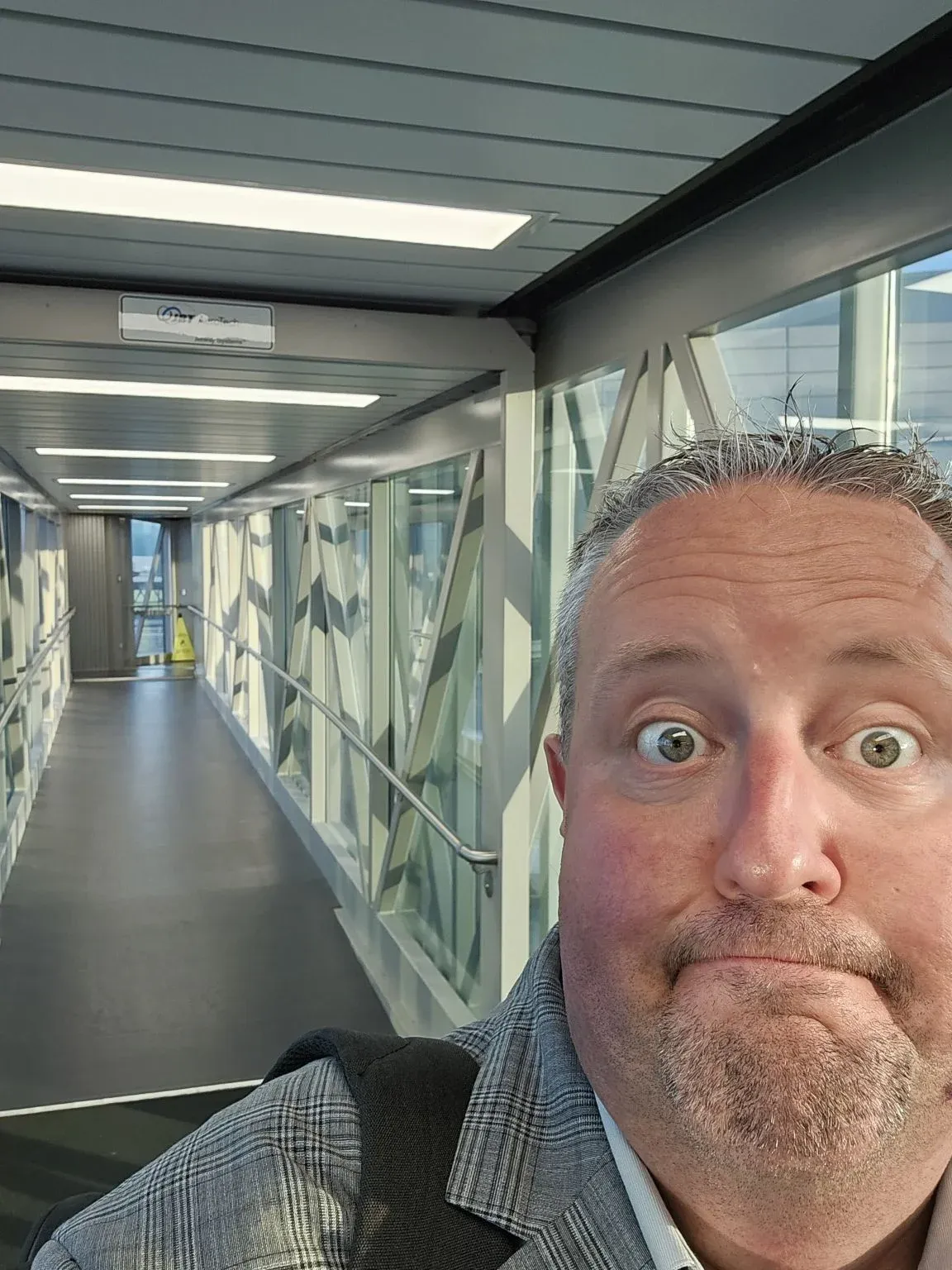 Traveler in an airport boarding corridor