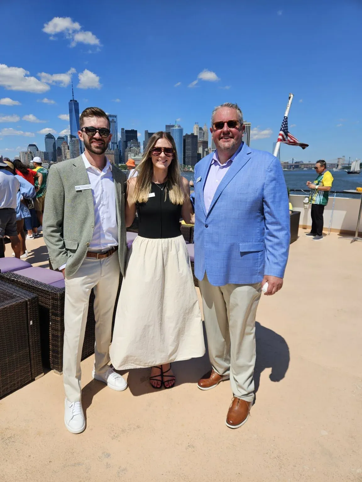 Three guests at an outdoor event