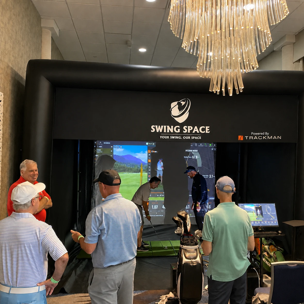 Guests receiving professional golf swing instruction at an ISM hospitality event