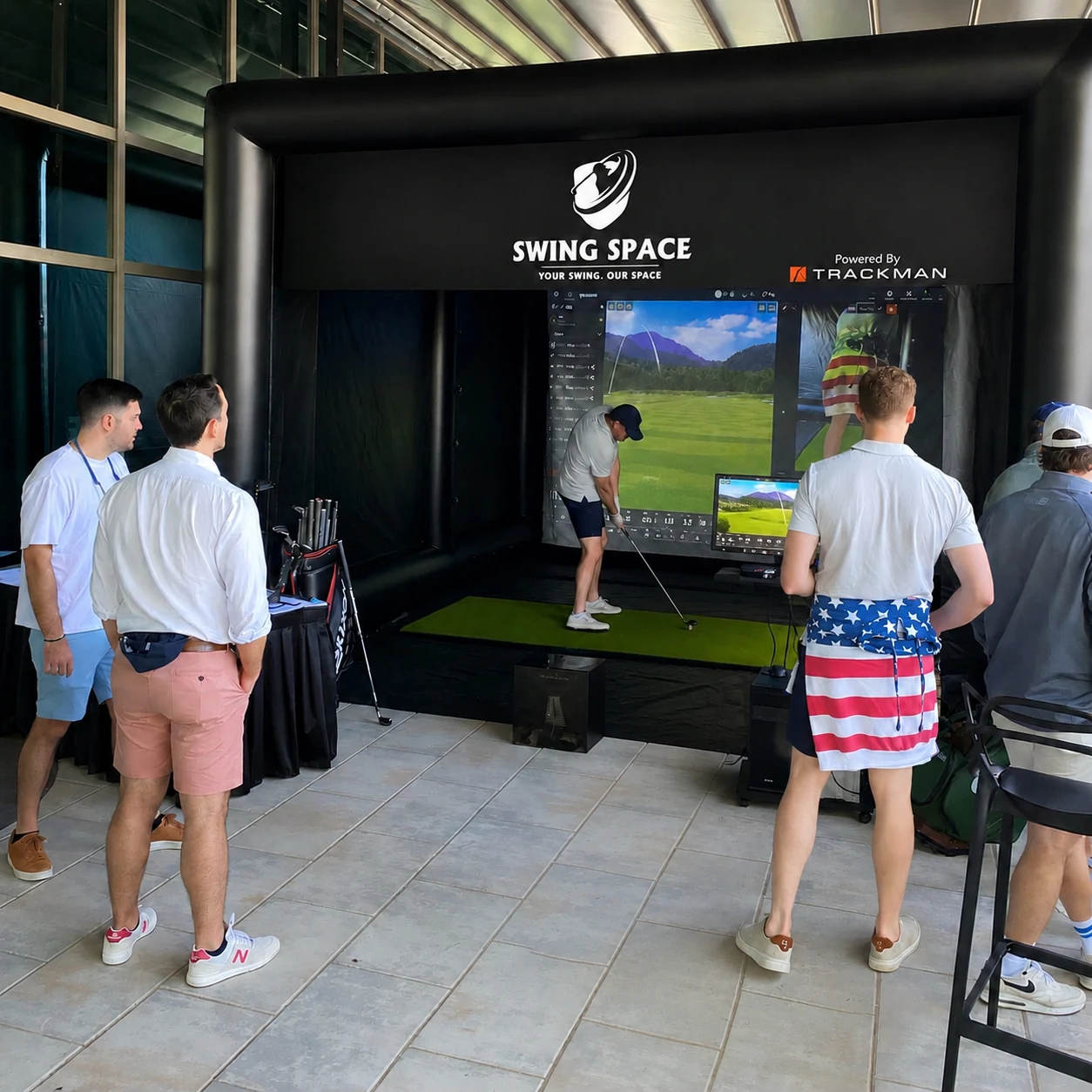 Guests receiving professional golf swing instruction at an ISM hospitality event